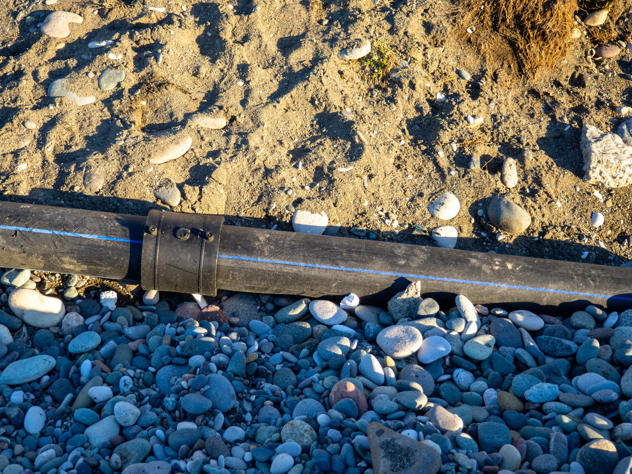 Black water pipe joined by a coupler.